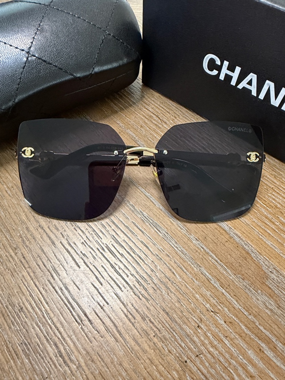 Chanel Women's Black and Gold Rimless Square Sunglasses